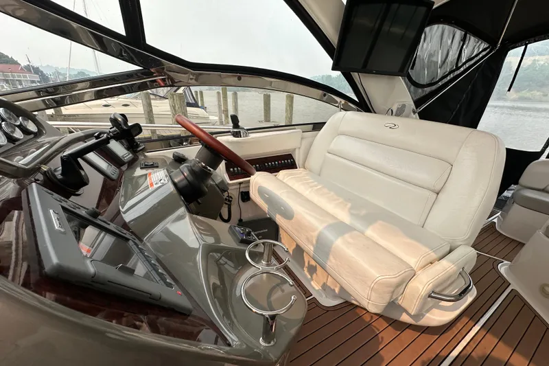 Slide: The Image of Interior of a 2008 Regal Commodore 4060 yacht with luxurious seating and modern controls. - 10