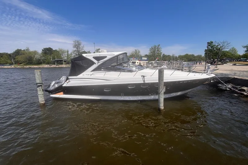 Slide: The Image of 2008 Regal Commodore 4060 yacht docked on a sunny day by the shore. - 1