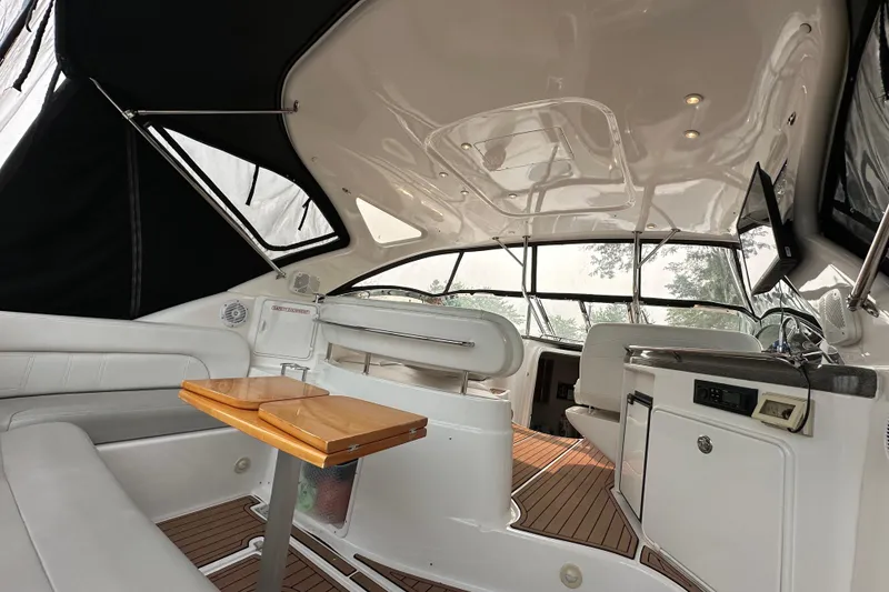 Slide: The Image of Interior of a 2008 Regal Commodore 4060 yacht with sleek seating and wooden table. - 4