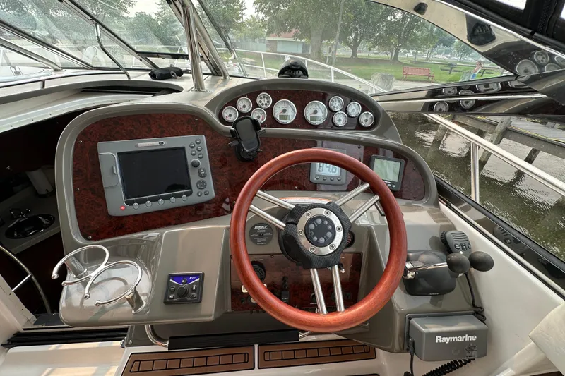 Slide: The Image of Cockpit of 2008 Regal Commodore 4060 yacht with steering wheel and navigation instruments. - 11