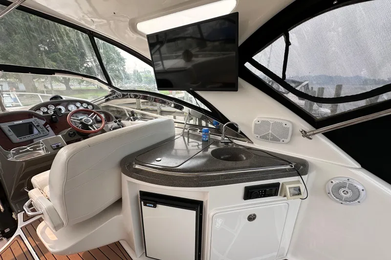 Slide: The Image of Interior of 2008 Regal Commodore 4060 yacht with helm, sink, and TV screen. - 7