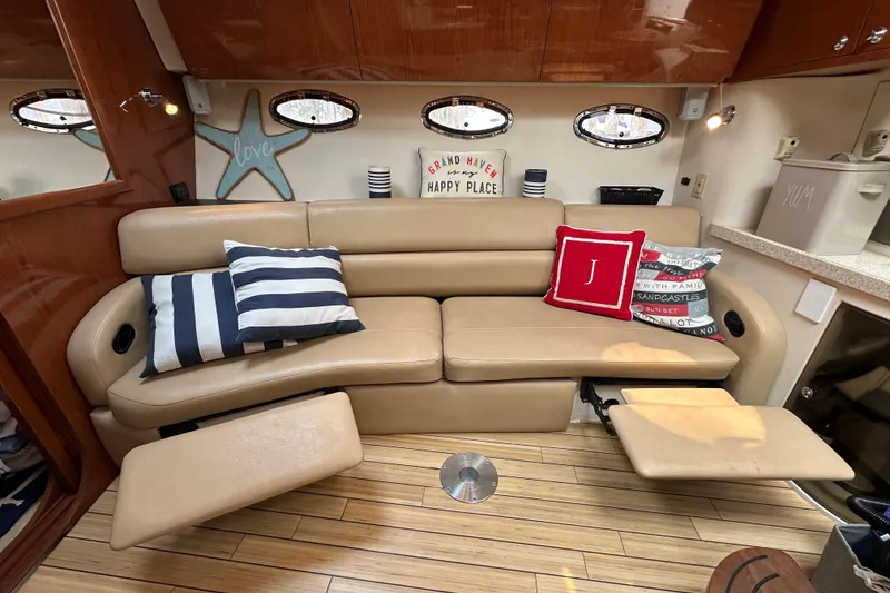 Slide: The Image of Luxurious interior of 2008 Regal Commodore 4060 yacht with beige leather seating and decorative pillows. - 19