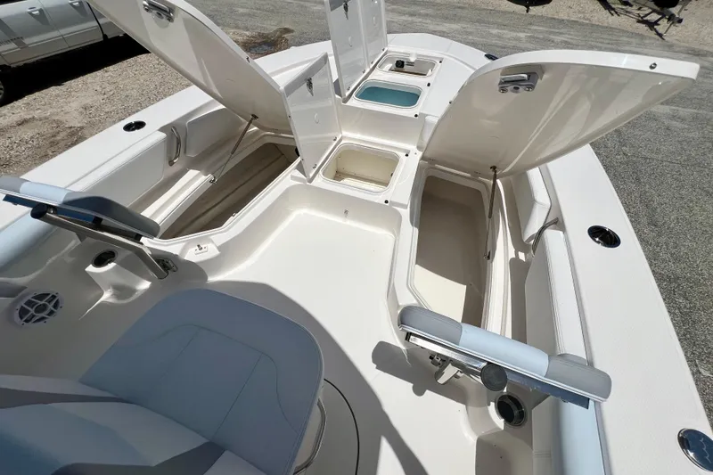 Slide: The Image of 2026 Robalo 246 Cayman boat interior with open storage compartments and seating. - 24