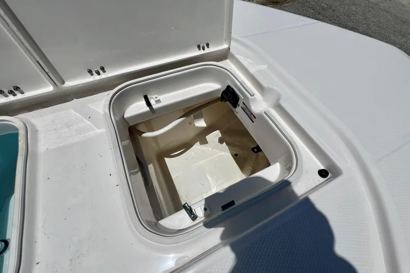 Slide: The Image of Open storage compartment on 2026 Robalo 246 Cayman boat deck. - 28