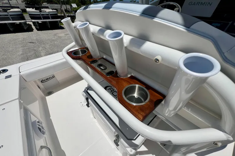 Slide: The Image of 2026 Robalo 246 Cayman boat interior with rod holders and cup holders. - 13