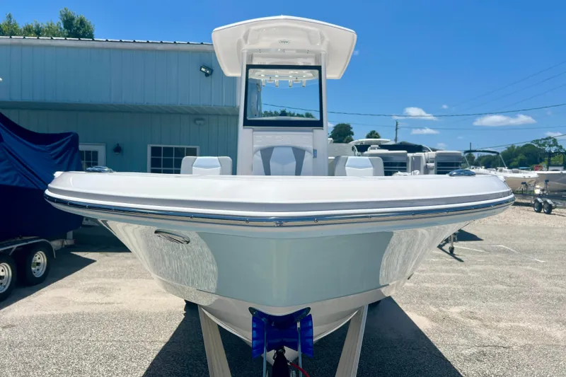 Slide: The Image of 2026 Robalo 246 Cayman boat displayed outdoors under clear blue sky. - 7