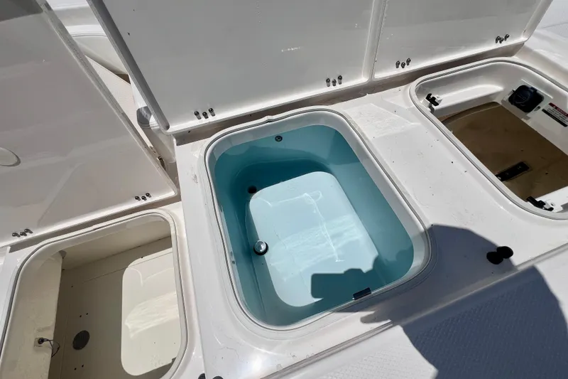 Slide: The Image of Livewell compartments on a 2026 Robalo 246 Cayman boat, open and ready for use. - 27