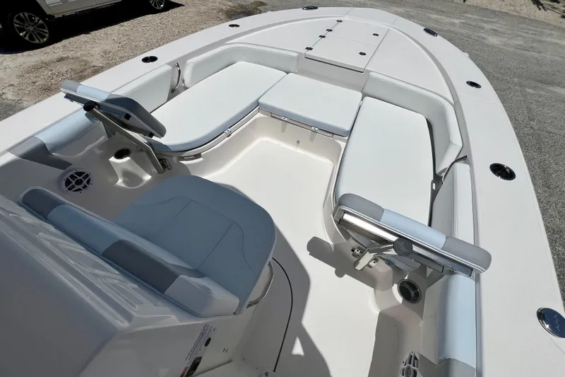Slide: The Image of 2026 Robalo 246 Cayman boat interior with white seating and steering console. - 20
