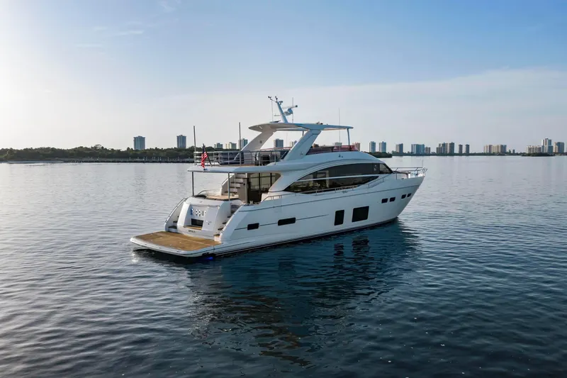 Slide: The Image of Luxurious 2018 Princess Y75 yacht cruising on calm waters near a city skyline. - 3