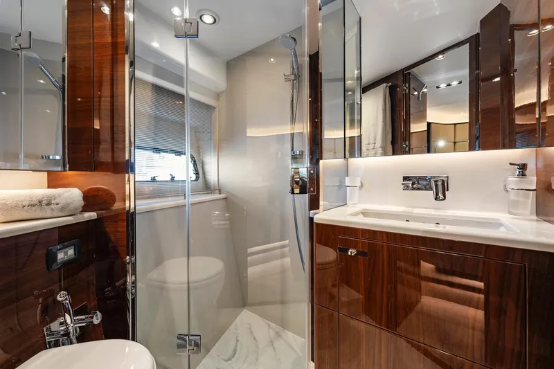 Slide: The Image of Luxurious bathroom interior on 2018 Princess Y75 yacht, featuring sleek wood finishes and modern fixtures. - 38