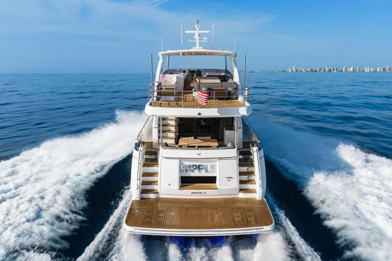 Slide: The Image of Luxury Princess Y75 yacht cruising on open sea, 2018 model, with city skyline in background. - 2