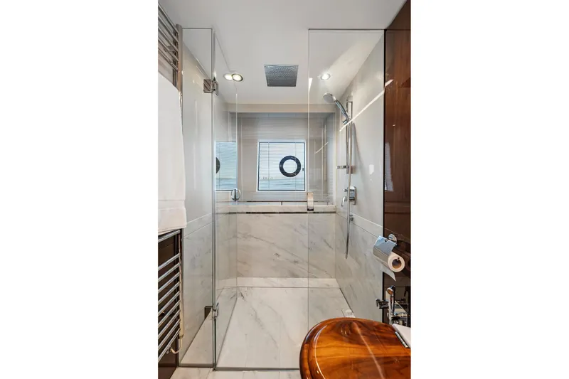 Slide: The Image of Luxurious yacht bathroom with glass shower, marble walls, and modern fixtures on Princess Y75, 2018. - 30
