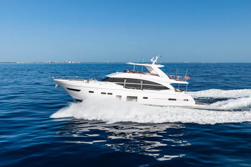 Slide: The Image of Luxury 2018 Princess Y75 yacht cruising on open blue sea under clear sky. - 79