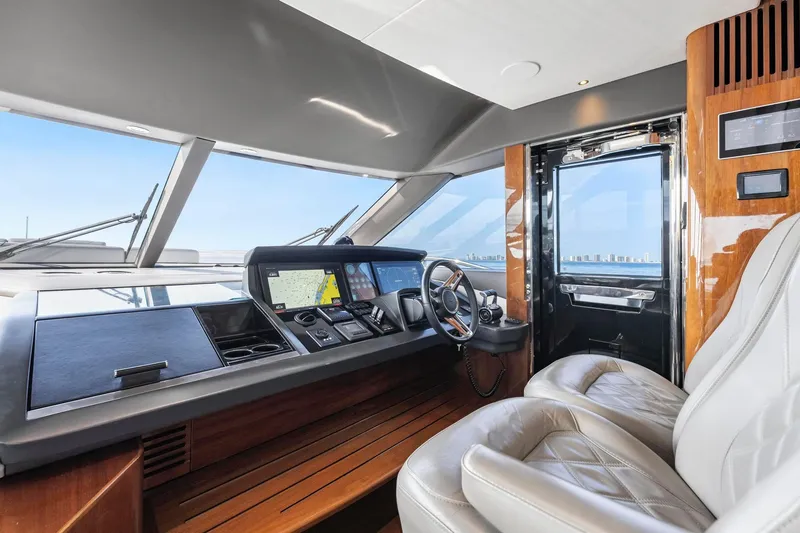 Slide: The Image of Luxurious helm of 2018 Princess Y75 yacht with modern navigation equipment and plush seating. - 19