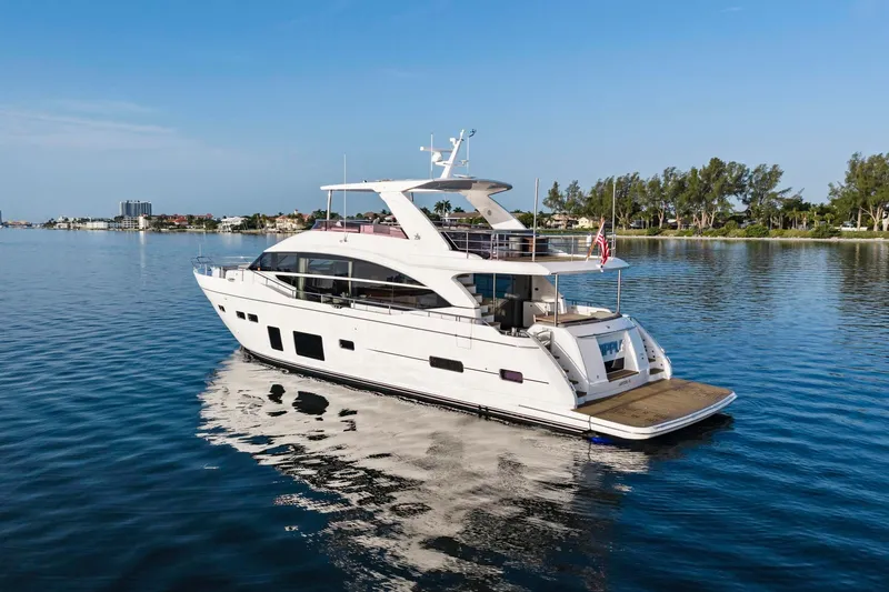 Slide: The Image of Luxurious 2018 Princess Y75 yacht cruising on serene waters under a clear blue sky. - 76