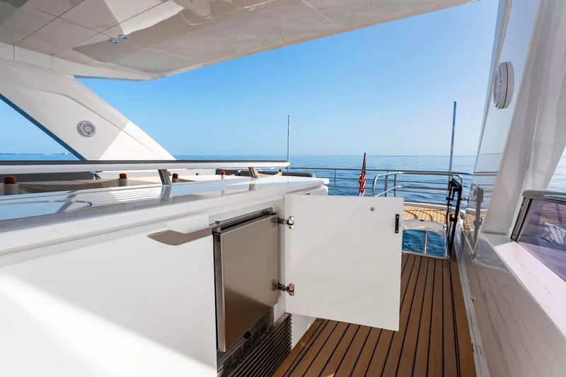 Slide: The Image of Luxurious 2018 Princess Y75 yacht deck with open cabinet, overlooking serene ocean view. - 61