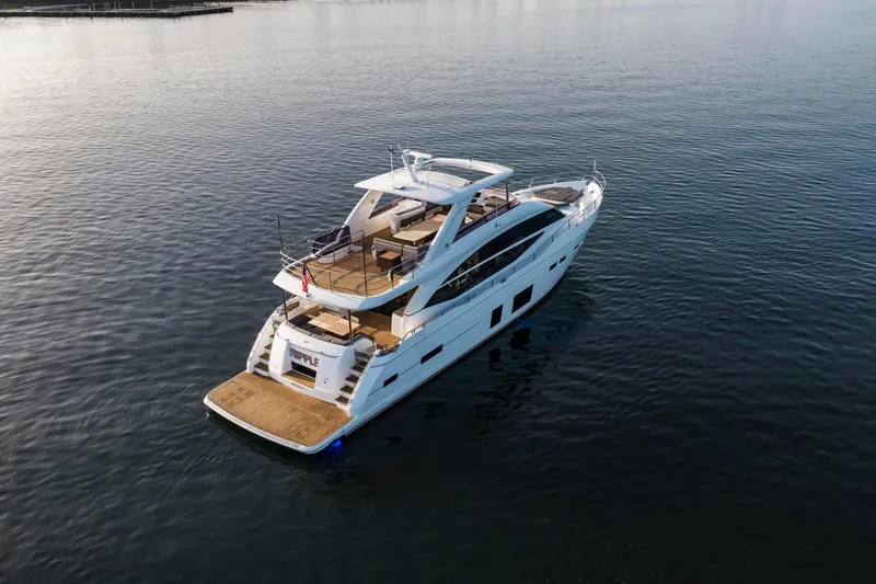Slide: The Image of Luxurious 2018 Princess Y75 yacht cruising on calm waters, showcasing elegant design and spacious deck. - 73
