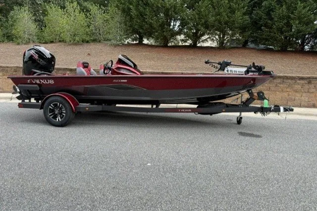The Image of 2027 Vexus AVX1880 boat on trailer, parked on a road with trees in the background. - 0
