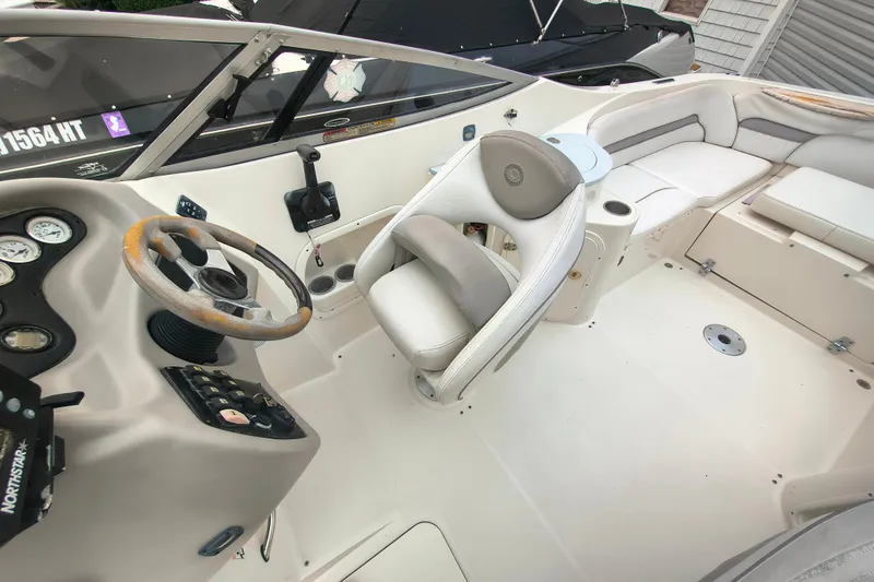 Slide: The Image of 2006 Stingray 250 LR boat interior with steering wheel, seating, and control panel. - 8