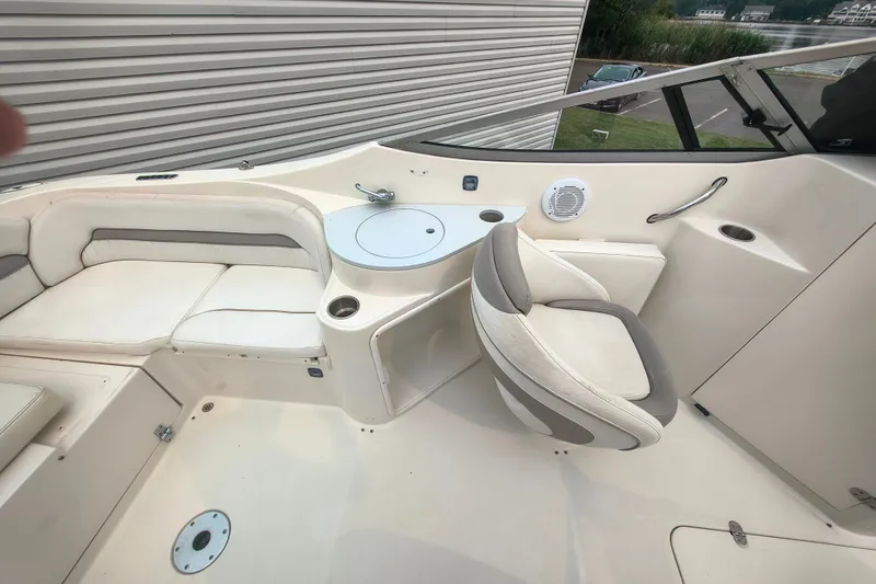 Slide: The Image of 2006 Stingray 250 LR boat interior with seating, table, and speaker. - 6