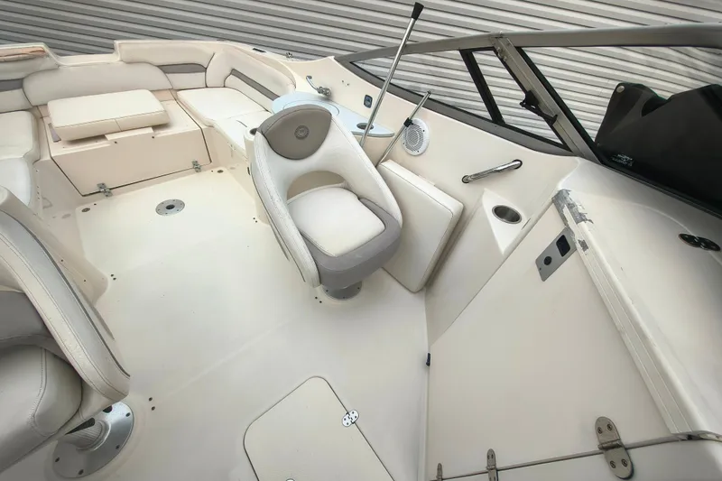 Slide: The Image of 2006 Stingray 250 LR boat interior with white seating and modern design. - 9