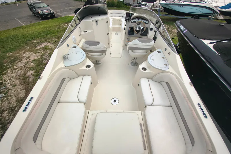 Slide: The Image of 2006 Stingray 250 LR boat interior with white seating and modern dashboard. - 4