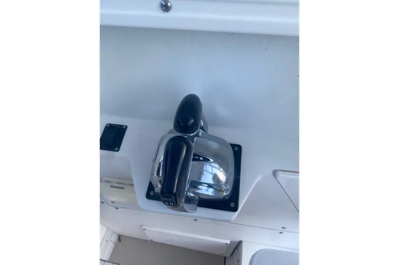 Slide: The Image of Throttle control of a 1994 Robalo 2440 Walkaround boat, featuring dual levers. - 6