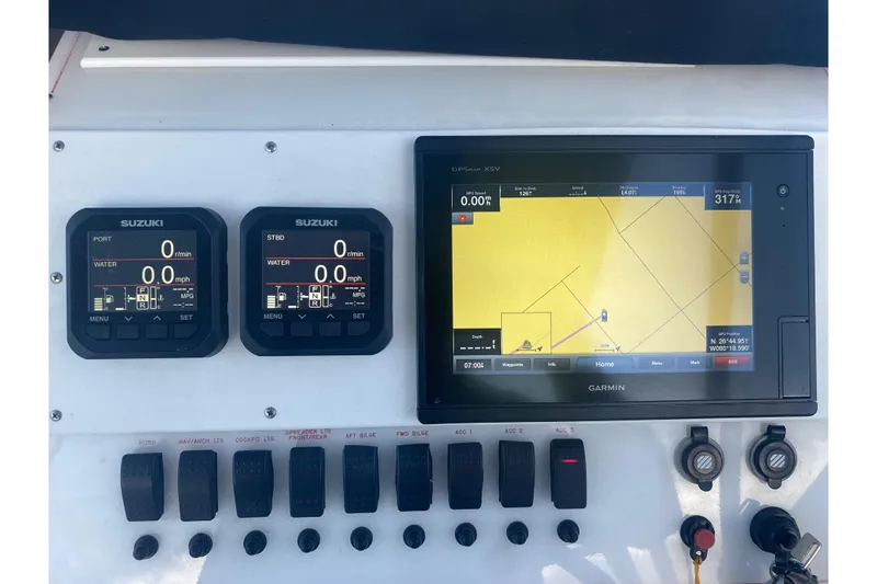 Slide: The Image of Control panel of a 1994 Robalo 2440 Walkaround with Suzuki displays and Garmin GPS. - 9