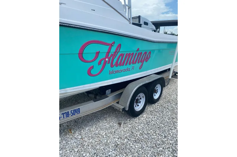Slide: The Image of 1994 Robalo 2440 Walkaround boat on trailer, labeled "Flamingo" in Islamorada, FL. - 1