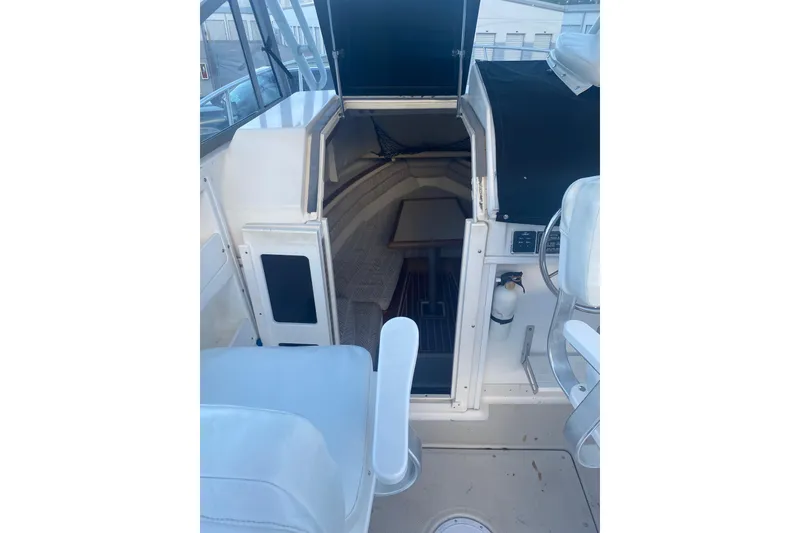Slide: The Image of 1994 Robalo 2440 Walkaround cabin interior with seating and table. - 5