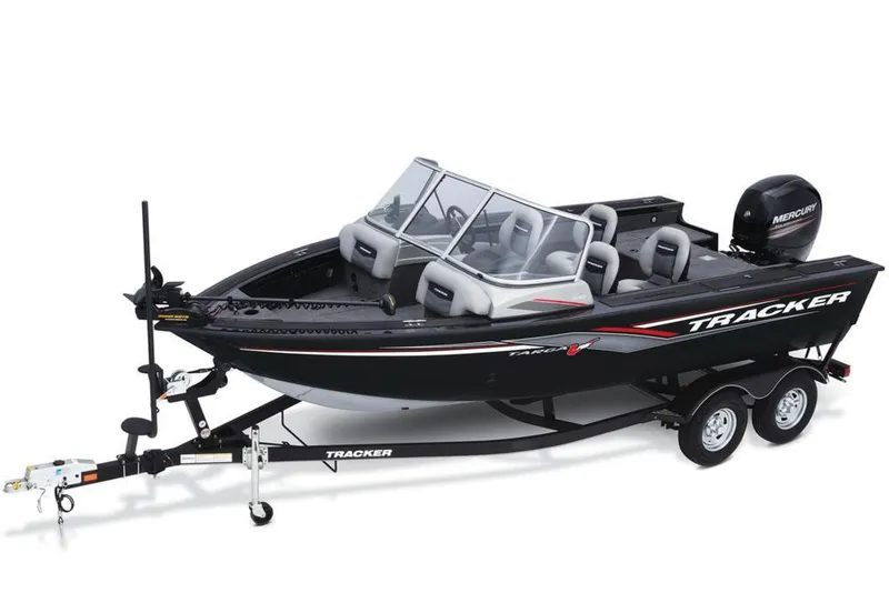 Slide: The Image of A black 2017 Tracker Targa V-18 WT boat on a trailer, featuring gray seats and a Mercury engine. - 12