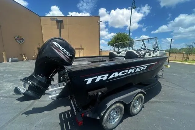 Slide: The Image of 2017 Tracker Targa V-18 WT boat with Mercury engine on trailer, parked outdoors. - 1