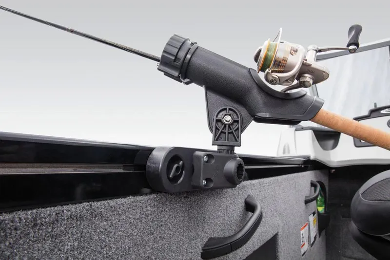 Slide: The Image of Fishing rod holder on a gray boat with padded seat and steering console. - 49