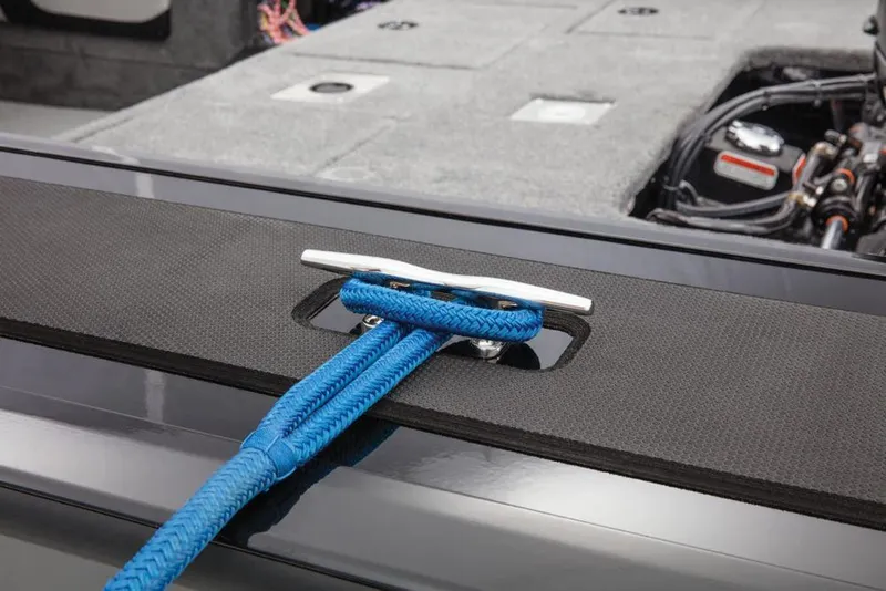 Slide: The Image of A blue rope is tied to a silver cleat on a boat. The deck is gray. - 24