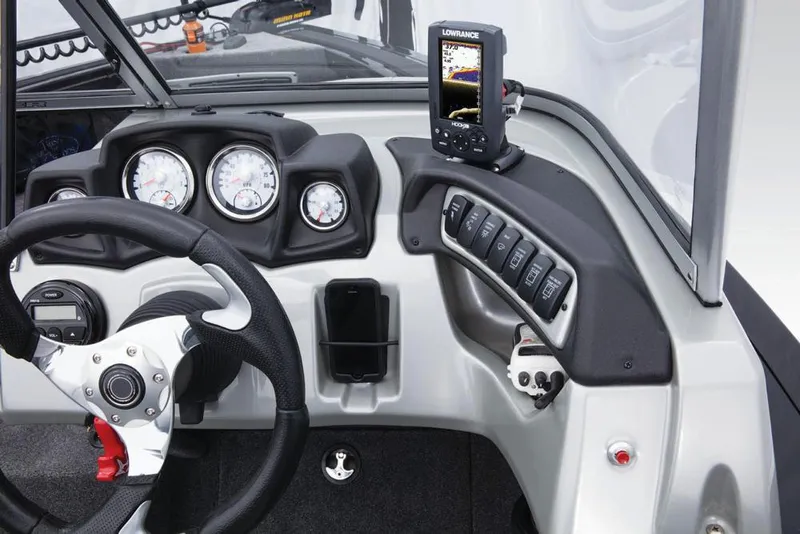 Slide: The Image of The image shows the dashboard of a Tracker Targa V-18 WT boat with steering wheel and instruments. - 43