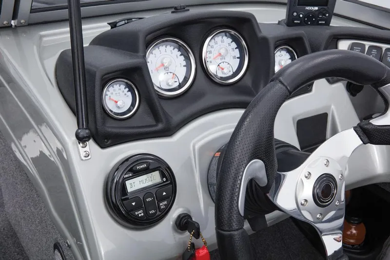 Slide: The Image of The image shows the dashboard of a 2017 Tracker Targa V-18 WT boat with multiple gauges and a steering wheel. - 38