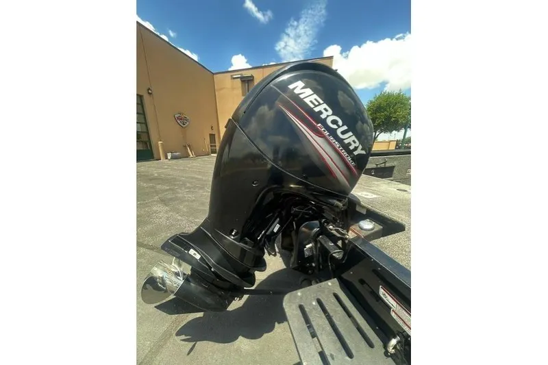 Slide: The Image of 2017 Tracker Targa V-18 WT with Mercury outboard motor in sunny outdoor setting. - 6