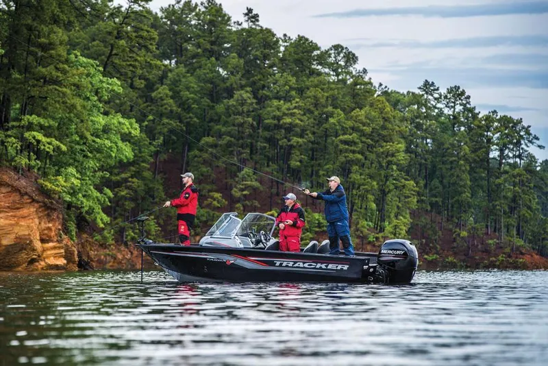Slide: The Image of Three people fishing on a Tracker Targa V-18 WT boat on a calm lake. - 14