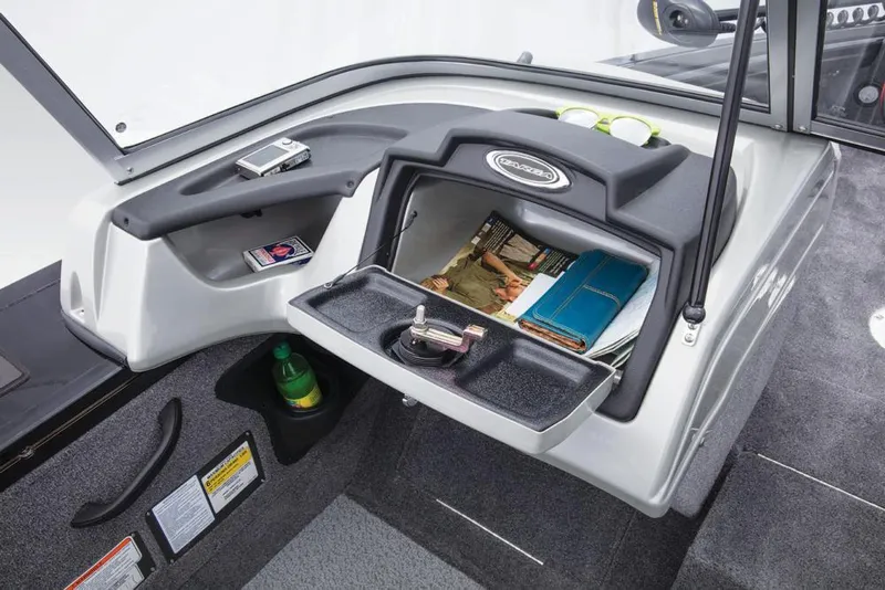 Slide: The Image of The image shows the dashboard of a 2017 Tracker Targa V-18 WT boat with storage space. - 36