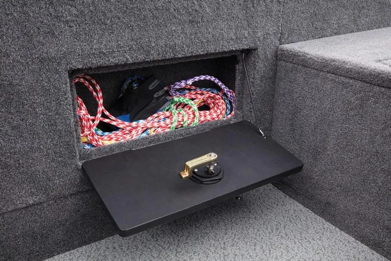 Slide: The Image of An open storage compartment in the boat reveals colorful ropes and a black bag. - 40