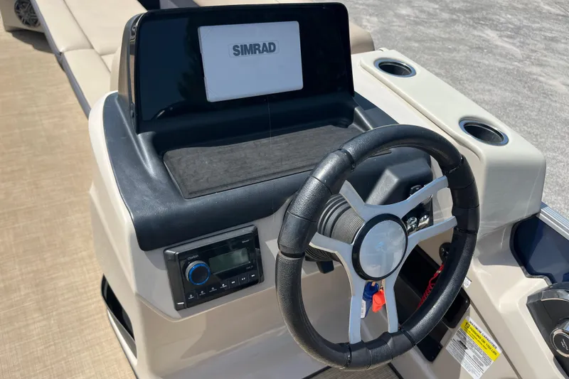 Slide: The Image of 2024 Harris Cruiser 230 dashboard with steering wheel and Simrad display. - 14
