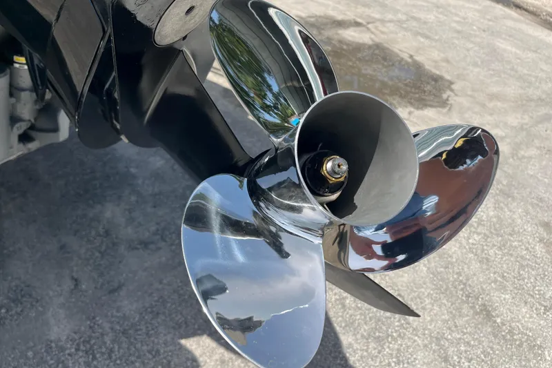 Slide: The Image of Close-up of a shiny propeller on a 2024 Harris Cruiser 230 boat. - 8