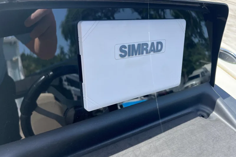 Slide: The Image of Simrad navigation system on 2024 Harris Cruiser 230 boat dashboard. - 16