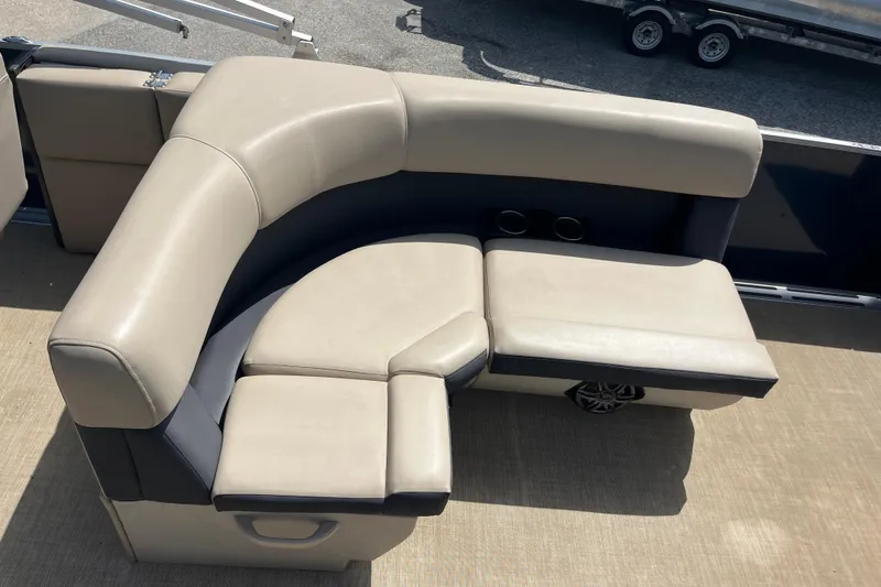 Slide: The Image of Luxurious seating on 2024 Harris Cruiser 230 pontoon boat, featuring beige upholstery and cup holders. - 12