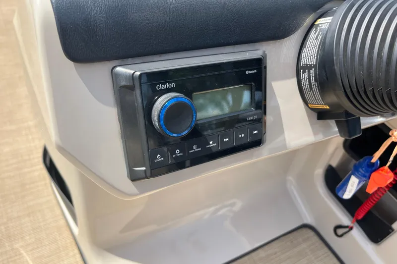 Slide: The Image of 2024 Harris Cruiser 230 dashboard featuring a Clarion audio system with Bluetooth connectivity. - 15