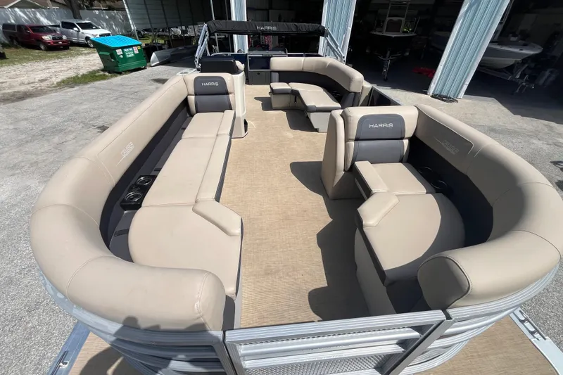 Slide: The Image of 2024 Harris Cruiser 230 pontoon boat with spacious seating and modern design. - 10