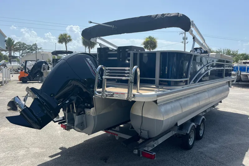 Slide: The Image of 2024 Harris Cruiser 230 pontoon boat with Mercury outboard engine on trailer. - 5