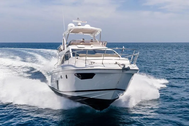 Slide: The Image of 2022 Azimut Fly 50 yacht cruising on open sea under clear skies. - 2