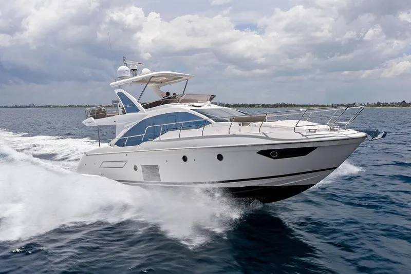 Slide: The Image of 2022 Azimut Fly 50 yacht cruising on open water under cloudy skies. - 11