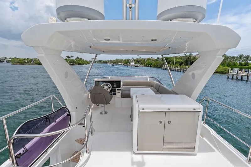 Slide: The Image of Flybridge view of 2022 Azimut Fly 50 yacht, featuring helm and seating area. - 19